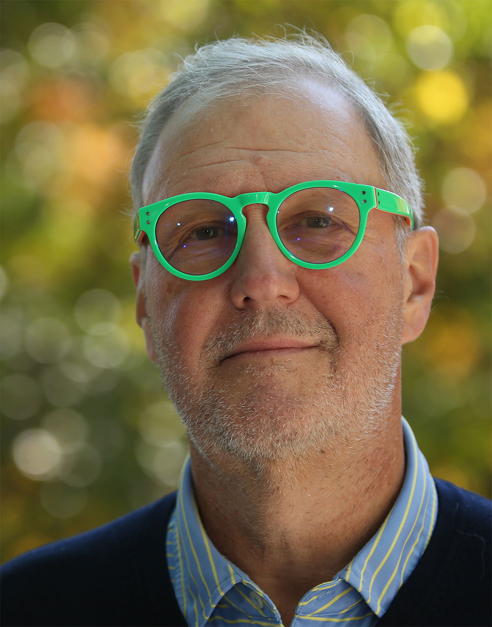 Albert Bartosic wearing green glasses and smiling