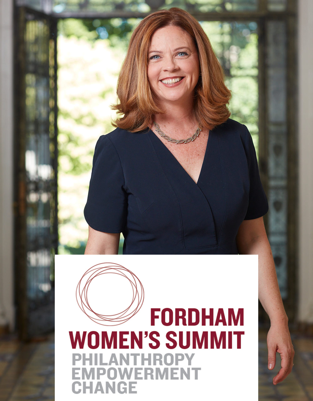 portrait of Tania Tetlow, standing in a hallway, wearing a dress and smiling; Fordham Women's Summit: Philanthropy, Empowerment, Change