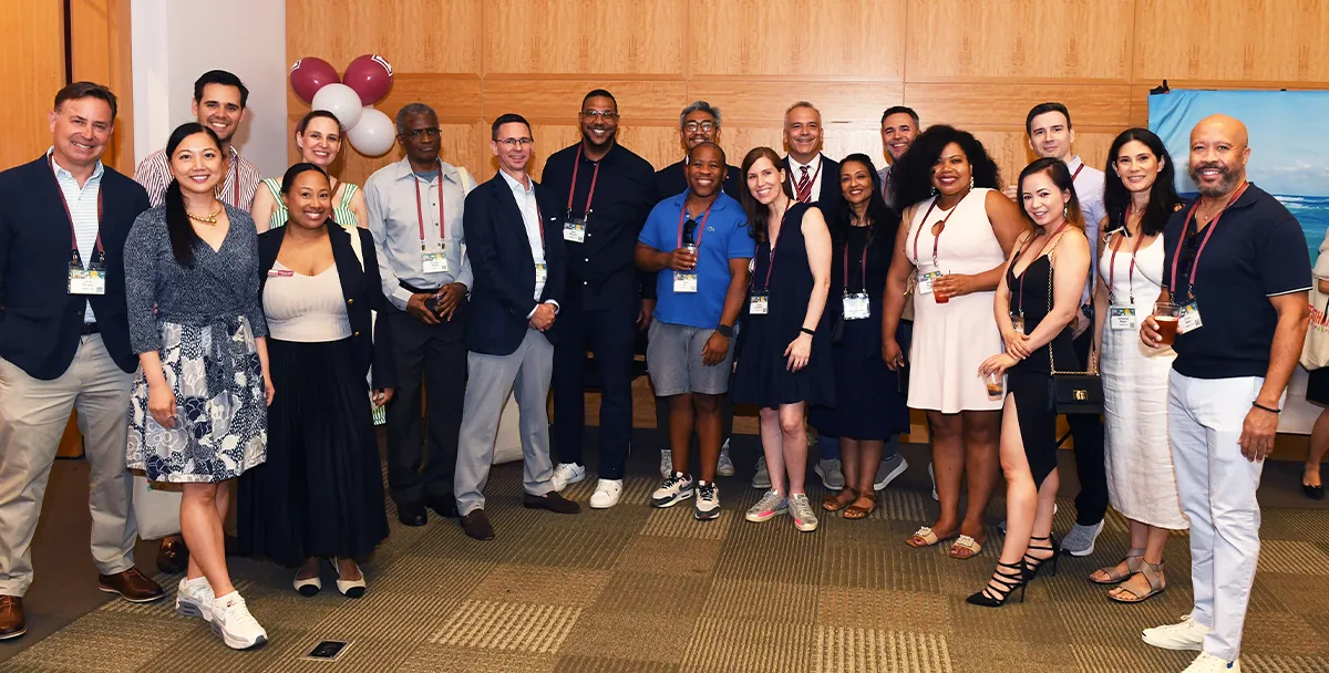 Associate Dean Francis Petit, Ed.D., shares a moment with EMBA alumni.